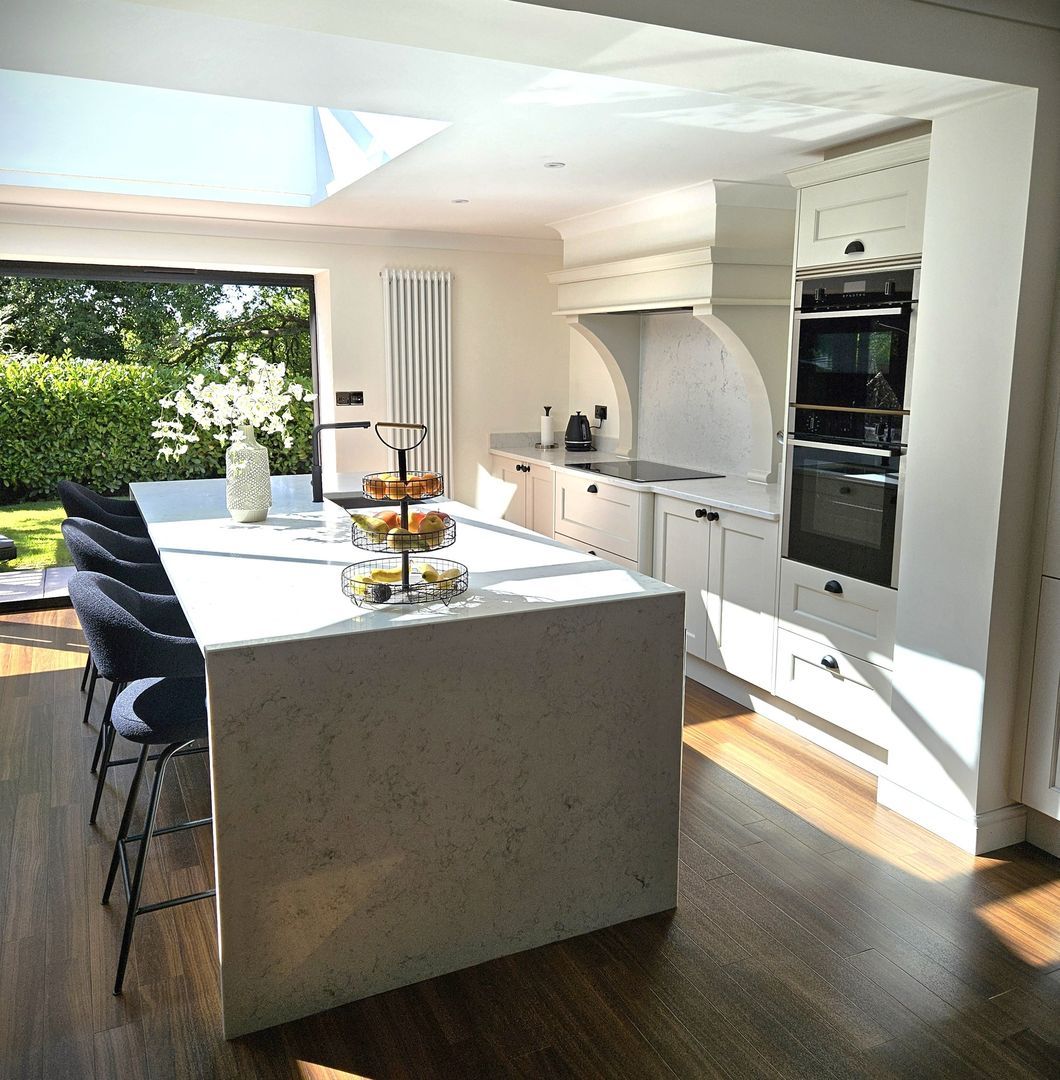 New modern kitchen with large sliding patio door looking out onto a luscious green garden.